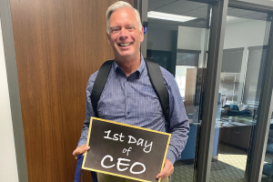 CEO Dave Willis holding a sign