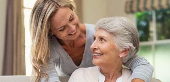 Adult female caring for older adult mother