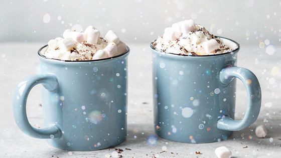 two blue cups of hot chocolate with whip cream