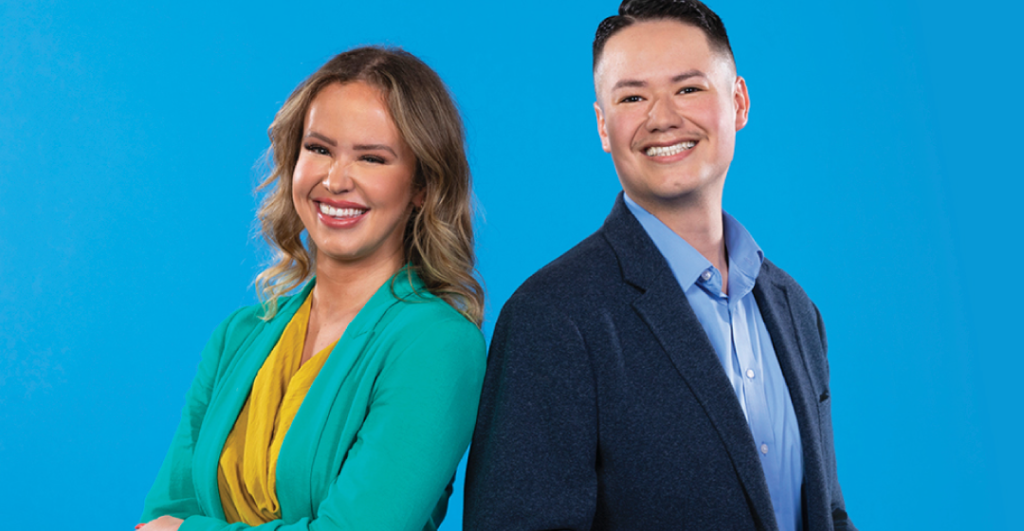 Woman and man employees smiling in suites with a bright blue background behind them