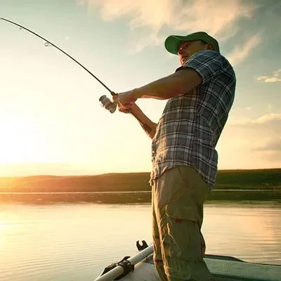 Fisherman in front of a sunset